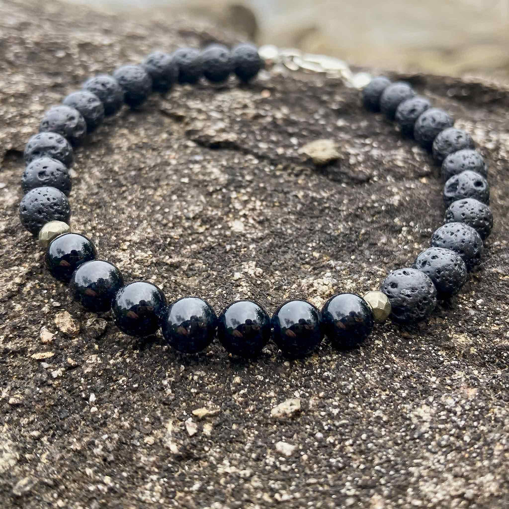 Close-up of black tourmaline and lava stone men’s bracelet showing bead texture