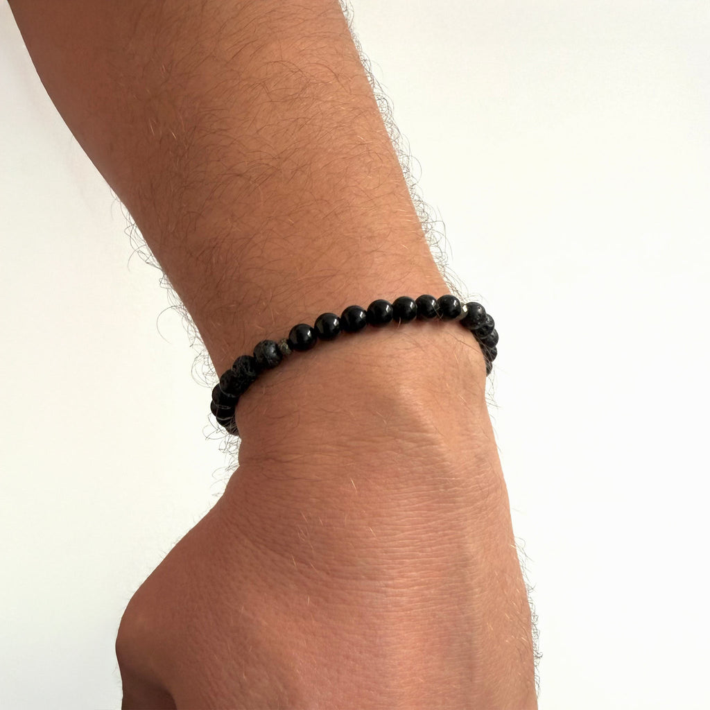 Men’s Inner Strength bracelet featuring black tourmaline and lava stone beads worn on the wrist