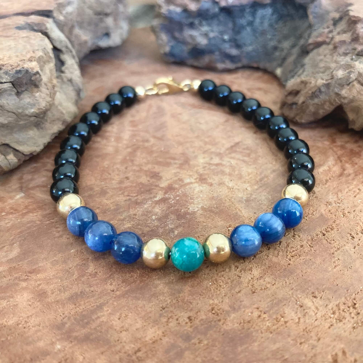 The Alchemist men's bracelet: black tourmaline, blue kyanite, a chrysocolla centre bead and 14k gold-fill, on stone