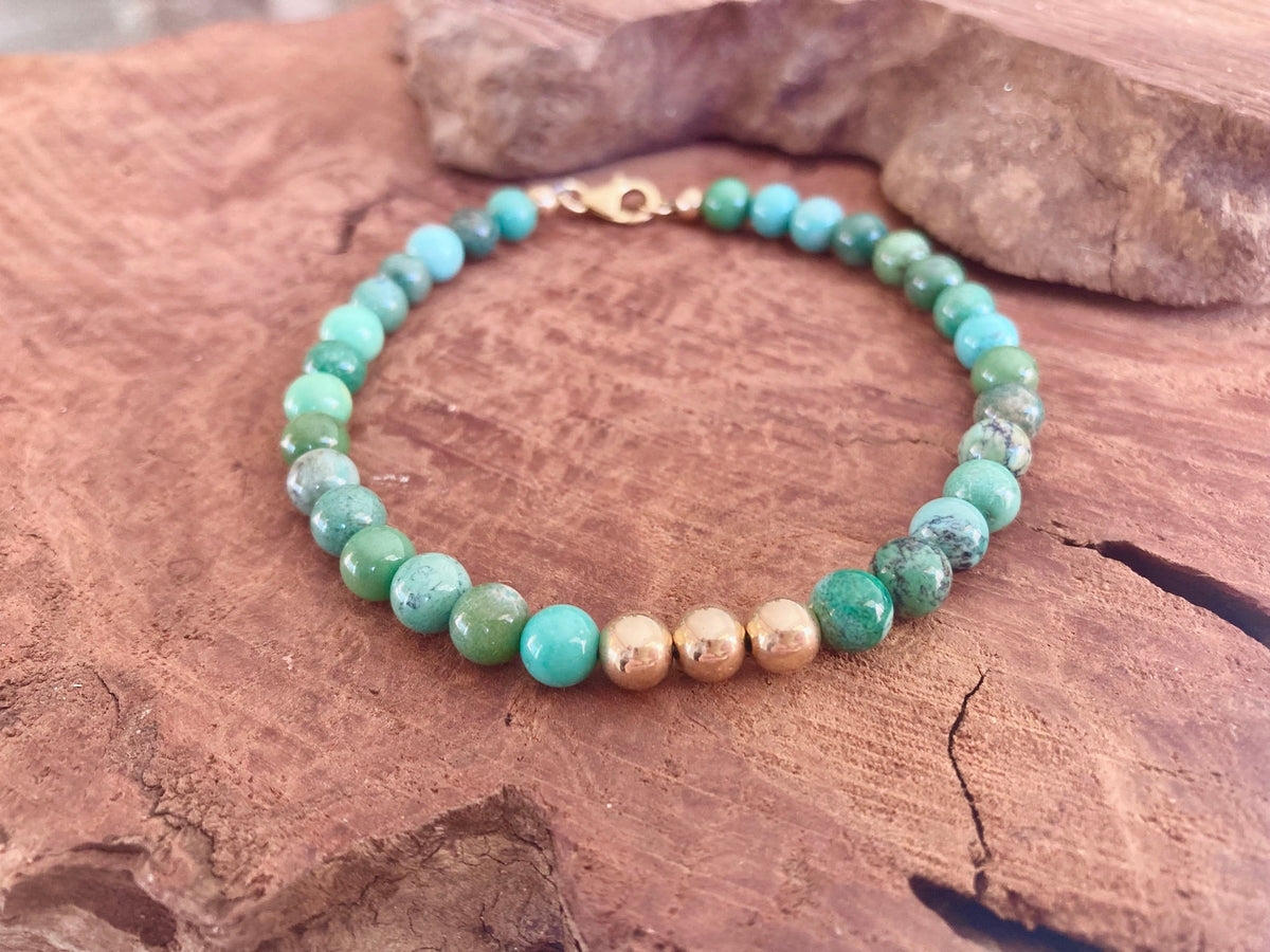 Australian chrysoprase bracelet with gold-fill clasp, on red sandstone