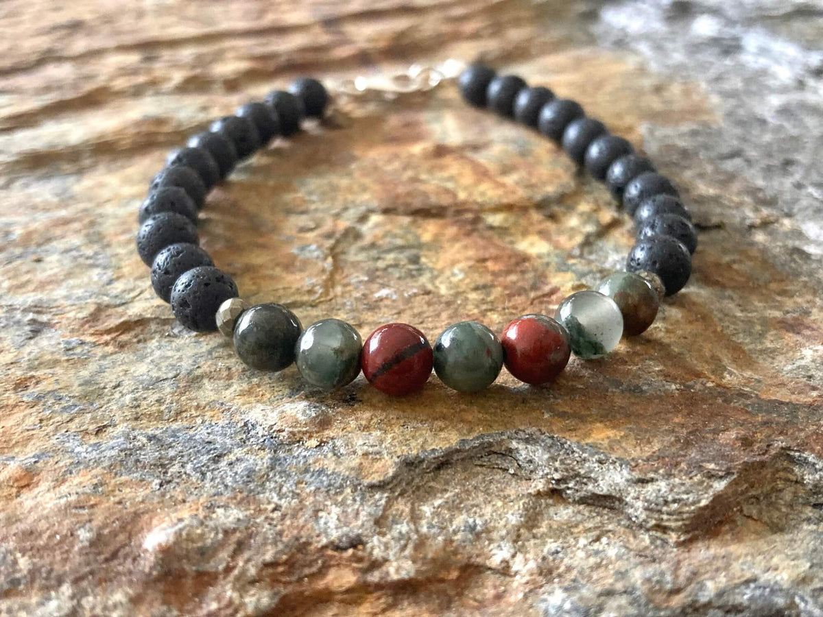 Bloodstone and lava stone men's bracelet on golden sandstone