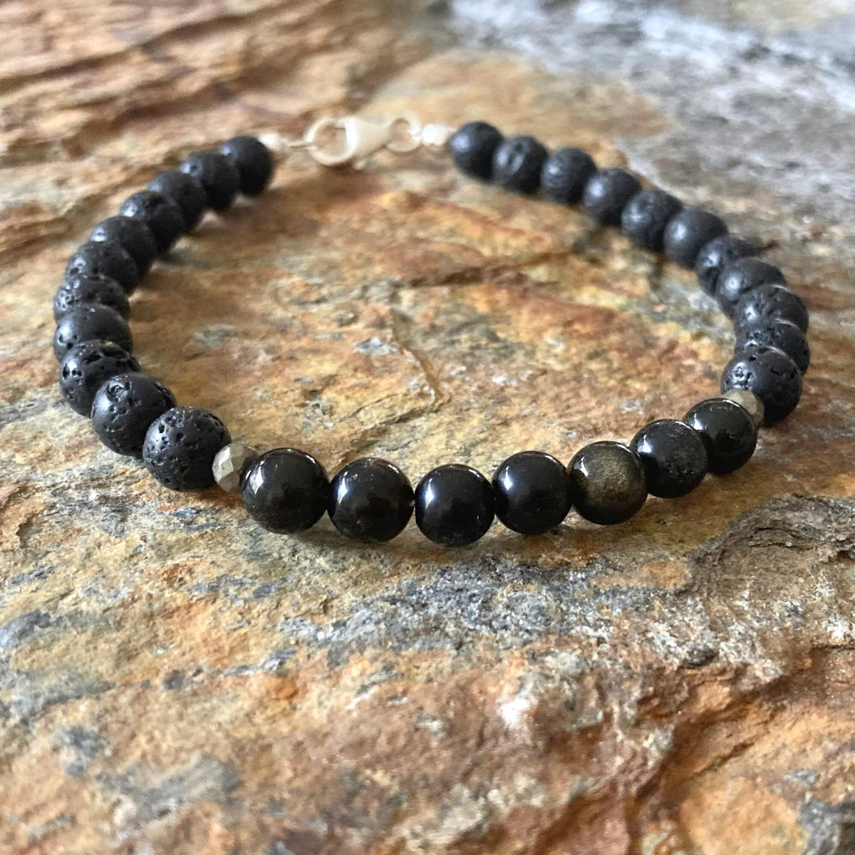 Close-up of glossy golden obsidian beads on the Facing Fears bracelet