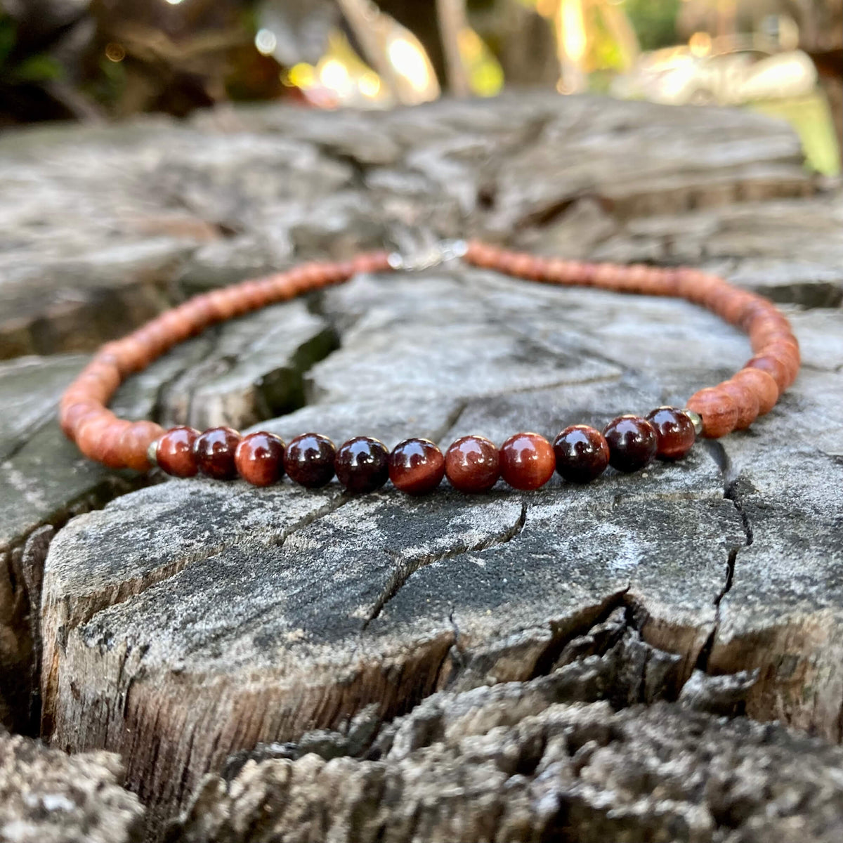 Close-up of red tiger's eye beads on the Motivation necklace