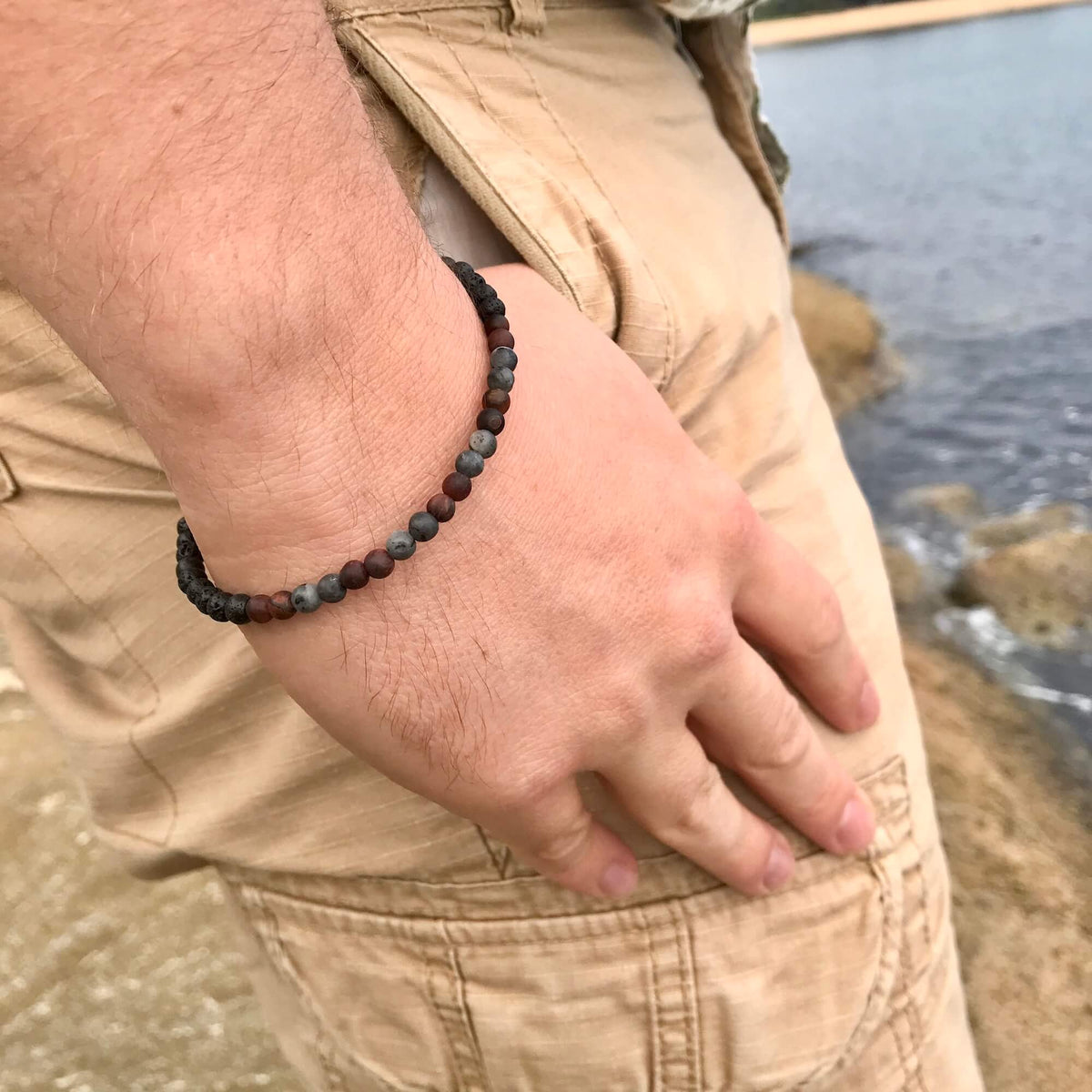 Drive bracelet on a man's wrist, hand resting on his hip