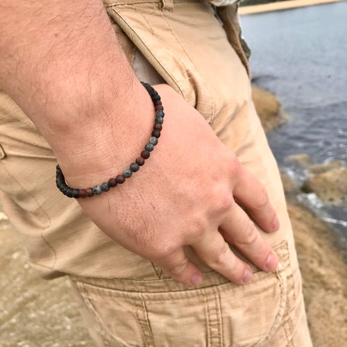 Drive bracelet on a man's wrist, hand resting on his hip