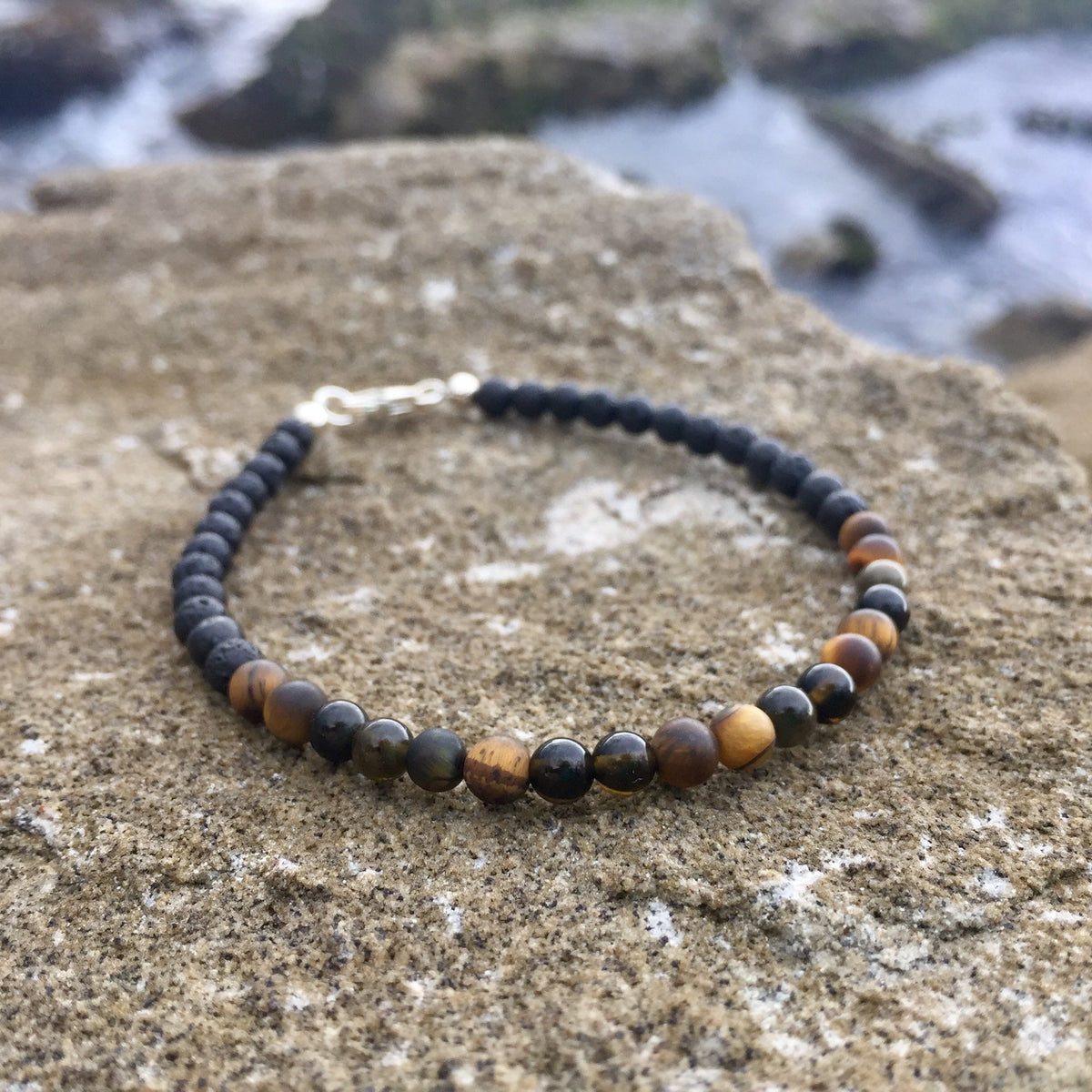 Fortitude men's bracelet: golden tiger's eye and golden obsidian with black beads, on sandstone