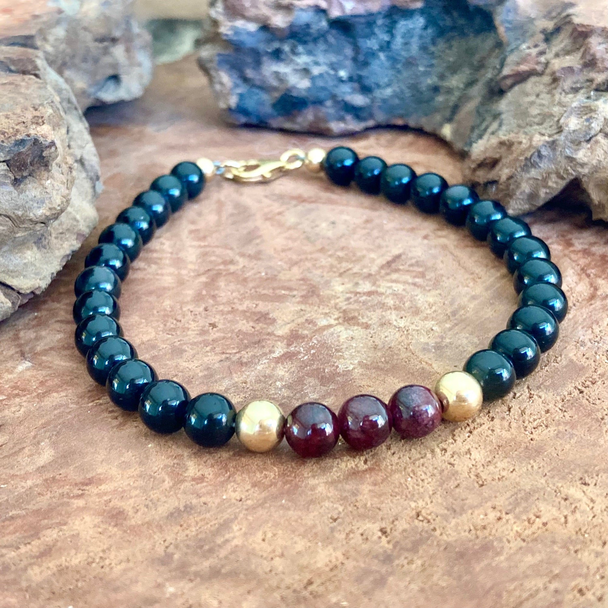 Handcrafted men's crystal bracelet with deep red garnet and black obsidian beads