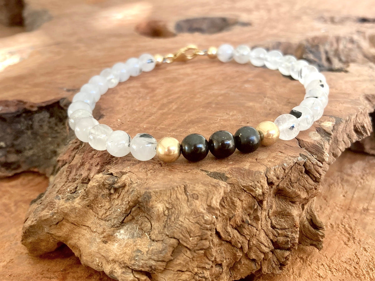 The Integrator bracelet on driftwood, shungite beads at the front