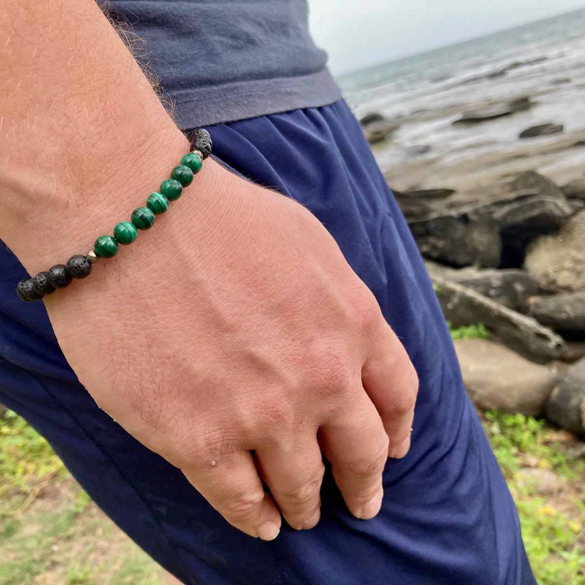 Manifestation bracelet on a man's wrist at the coast