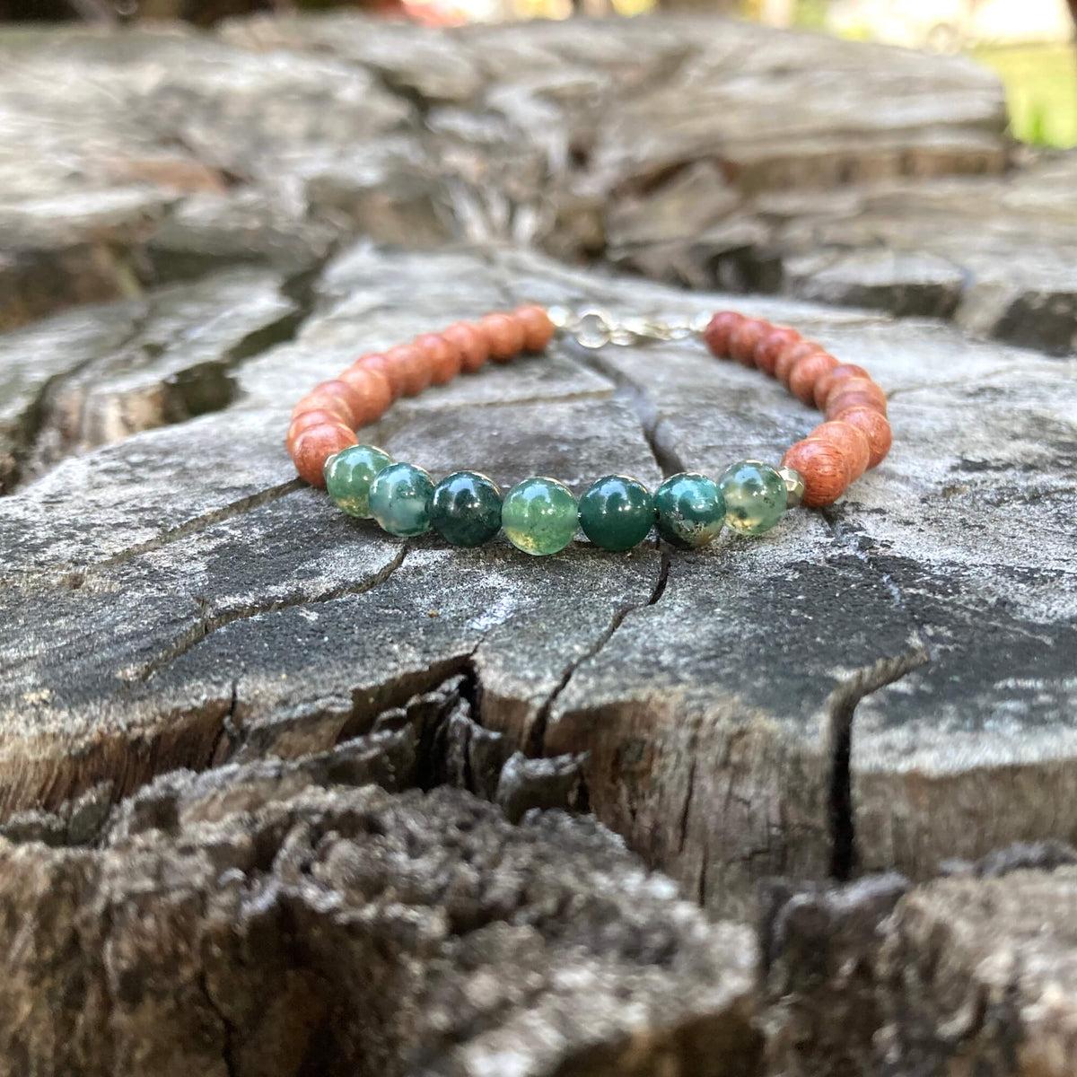 New Beginnings moss agate and wood bracelet on an old tree stump