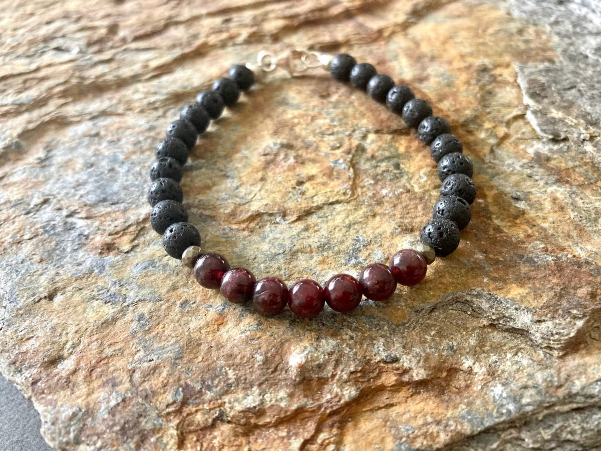 Prosperity bracelet from above on sandstone, sterling silver clasp at the top