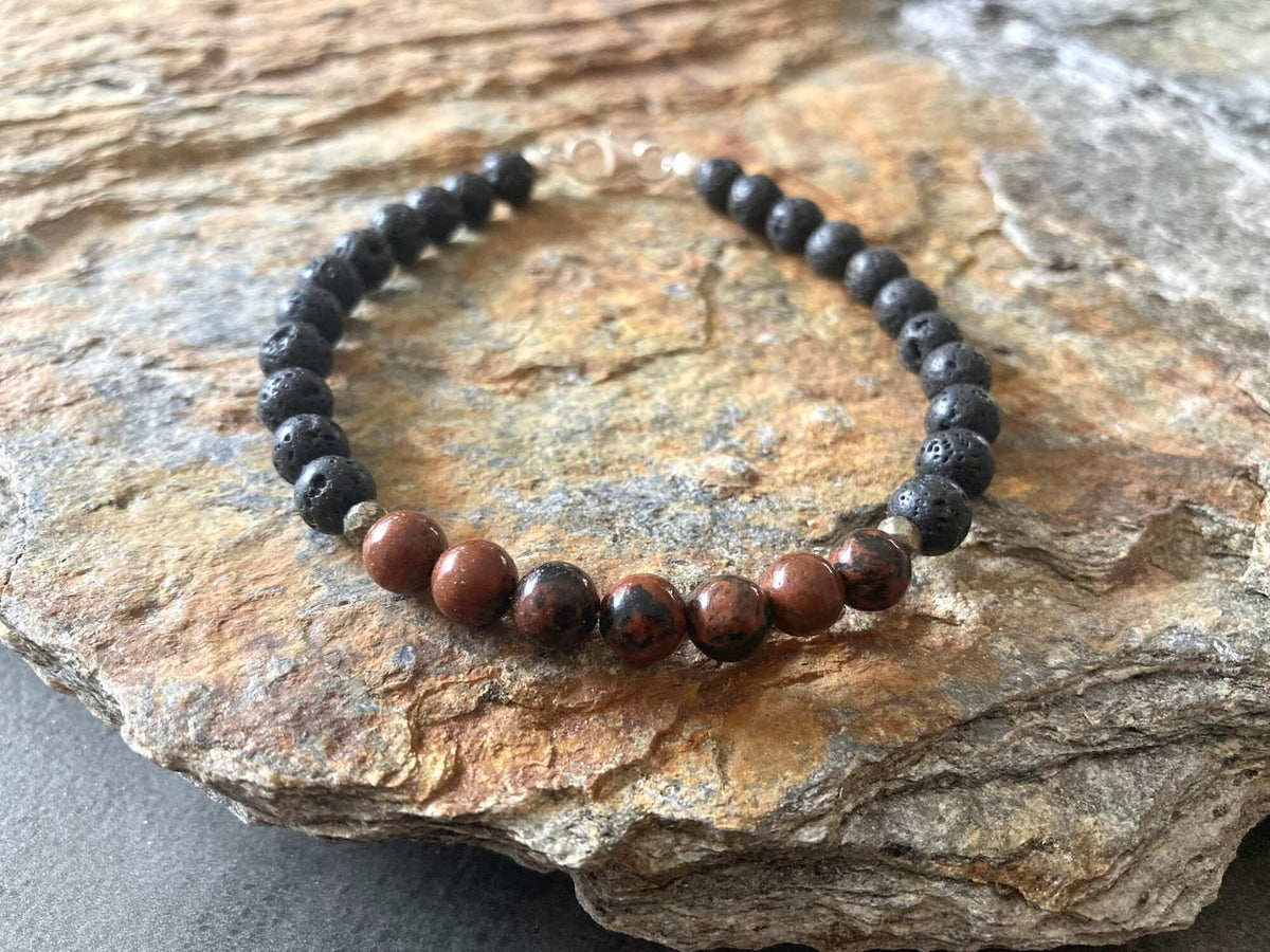 Self-Acceptance bracelet on layered sandstone, seen from the side