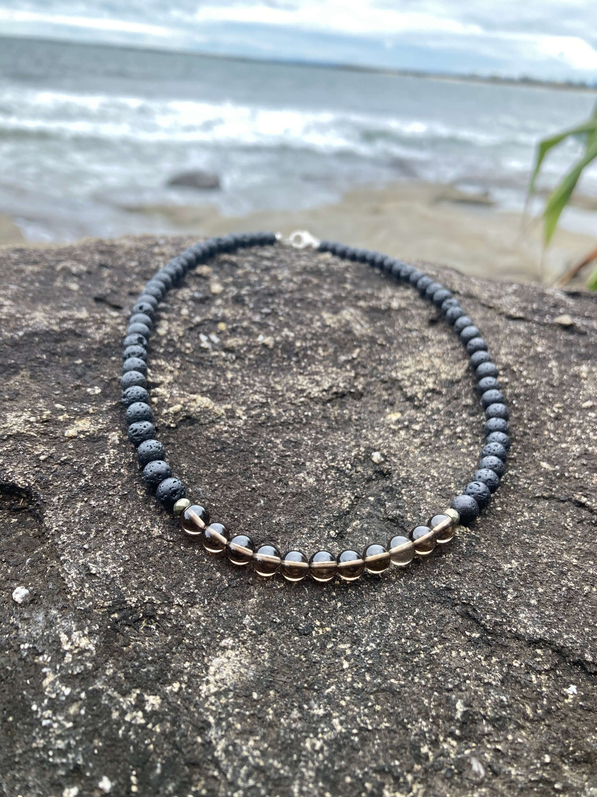 Self-Assurance necklace on coastal rock, seen from further back