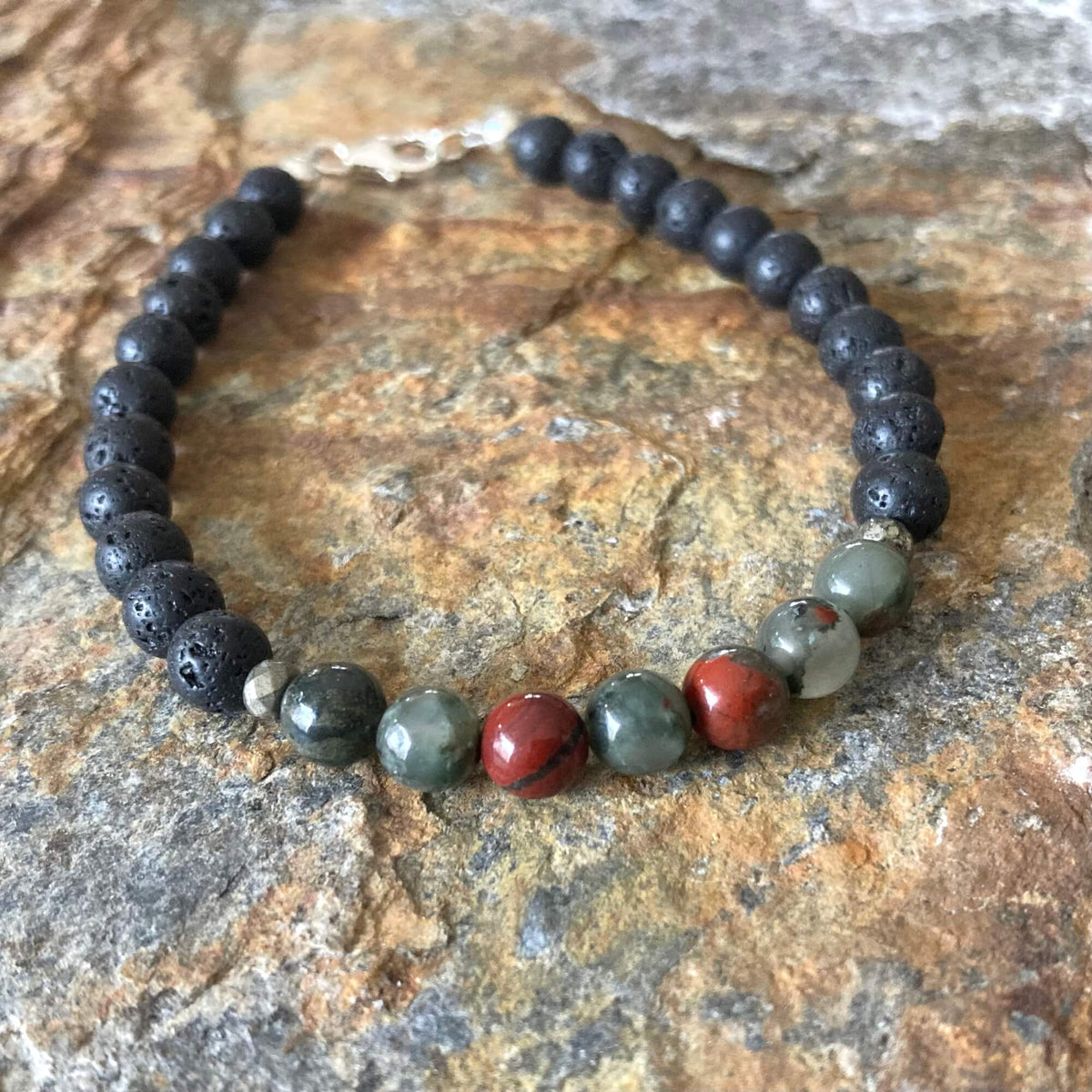Strength bracelet on orange-veined sandstone, bloodstone beads at the front