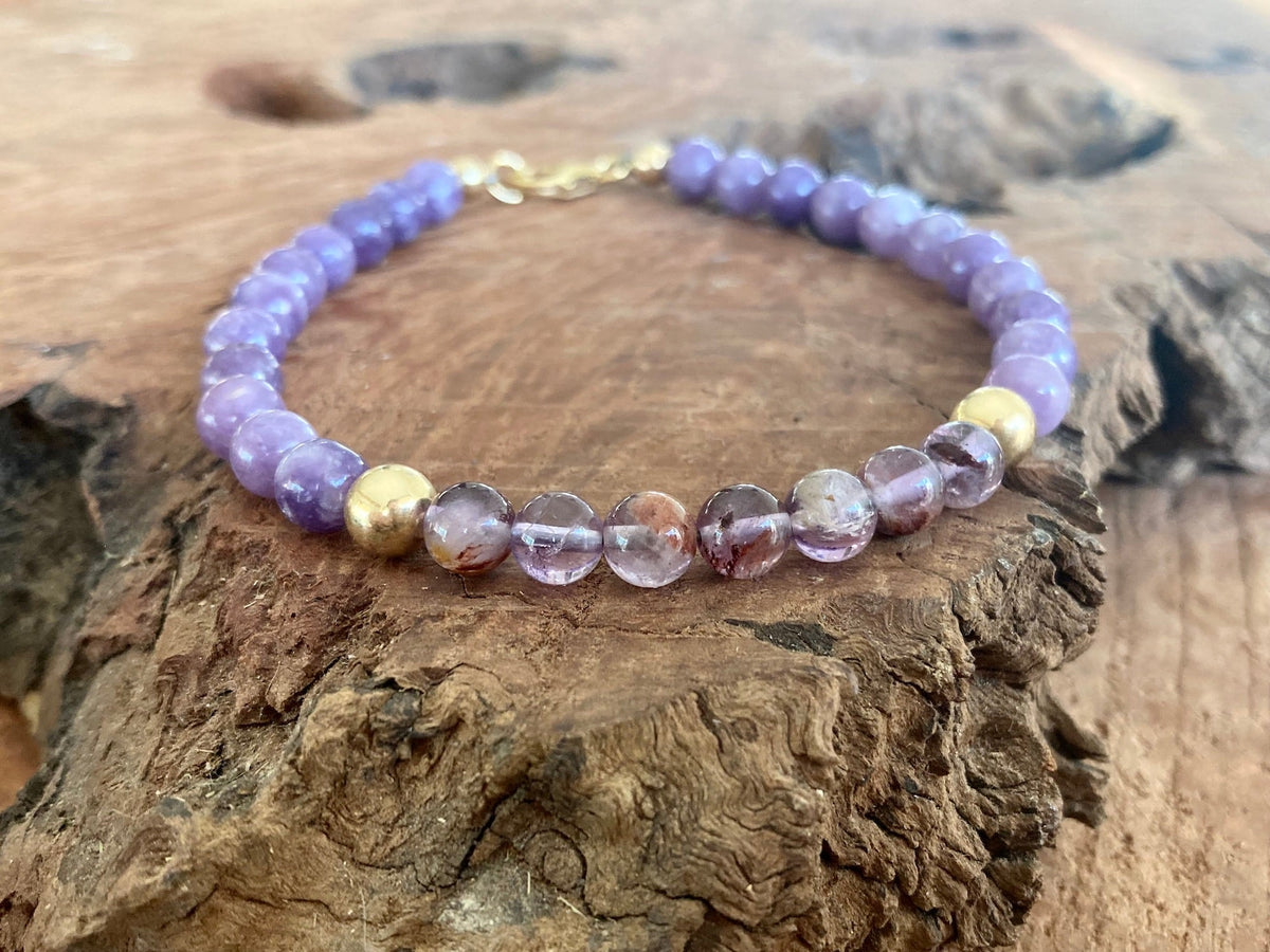 The Visionary bracelet on driftwood, gold-fill clasp at the back